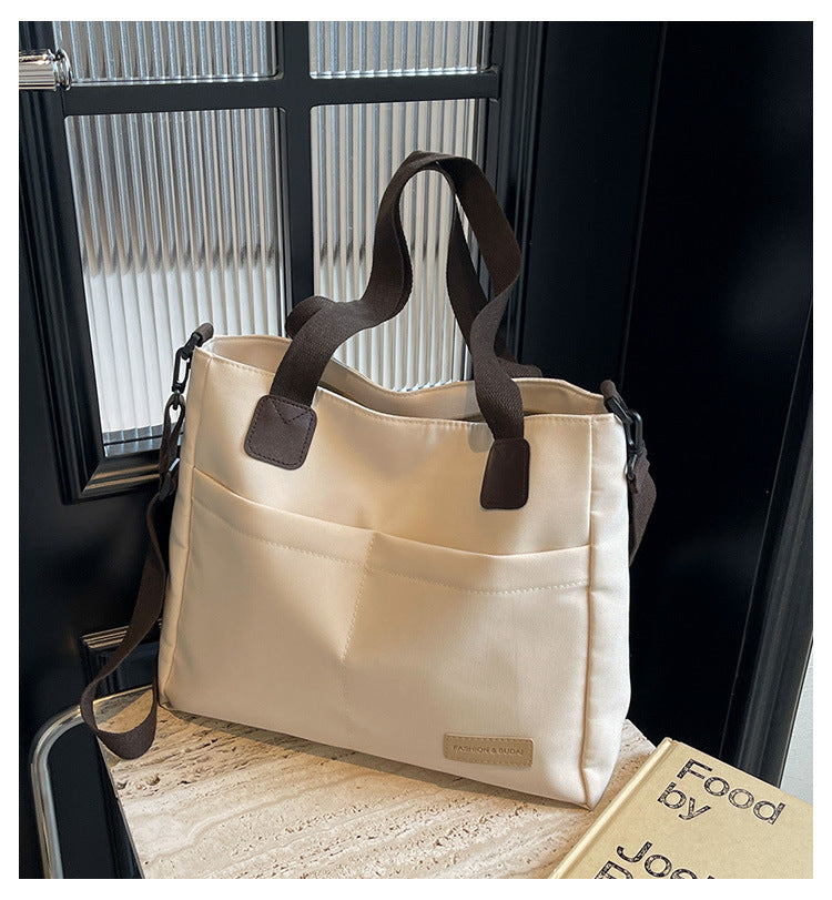 Stylish white canvas tote bag with detachable shoulder strap